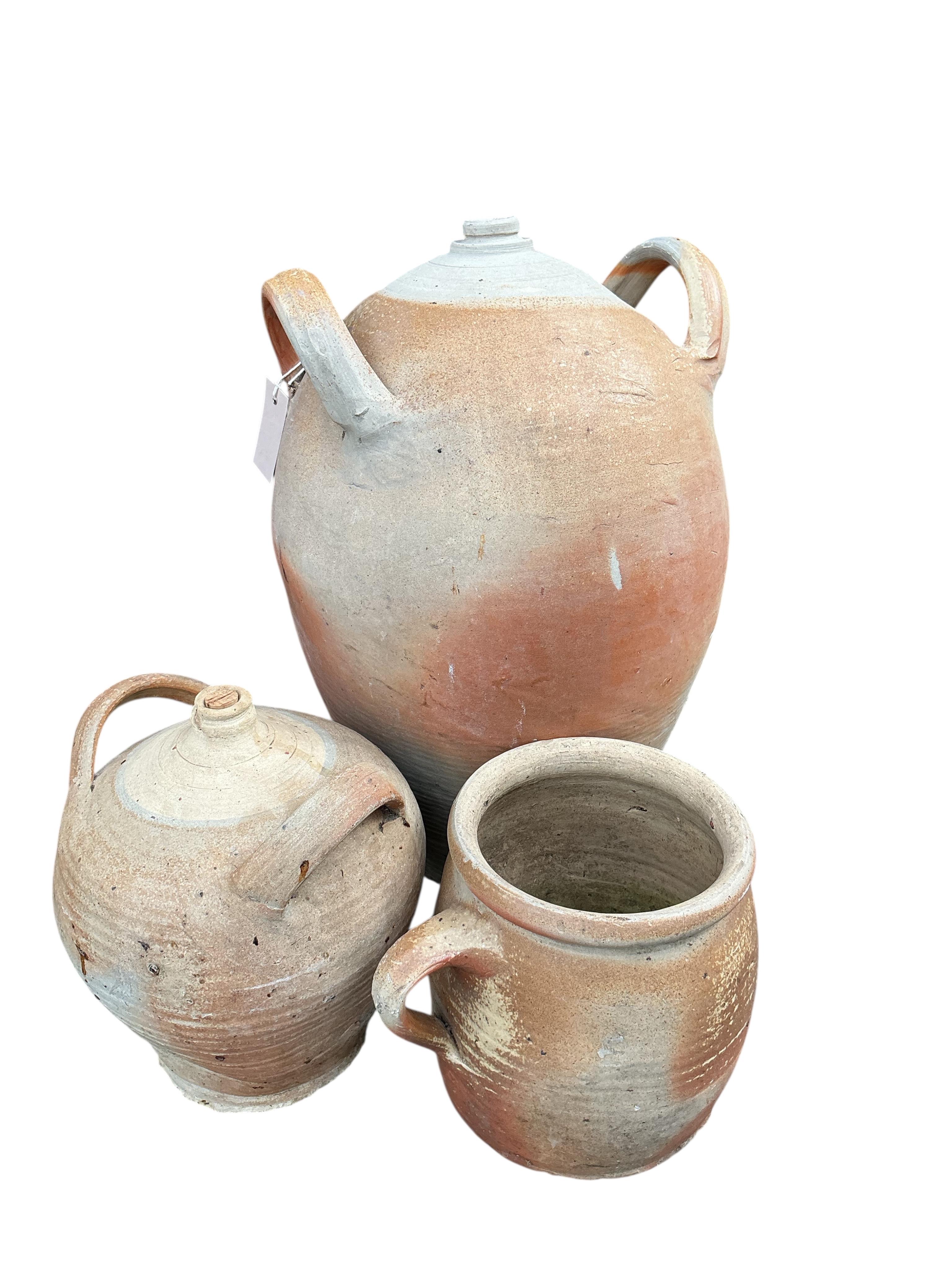 Nine assorted earthenware wine jars and containers, largest height 41cm